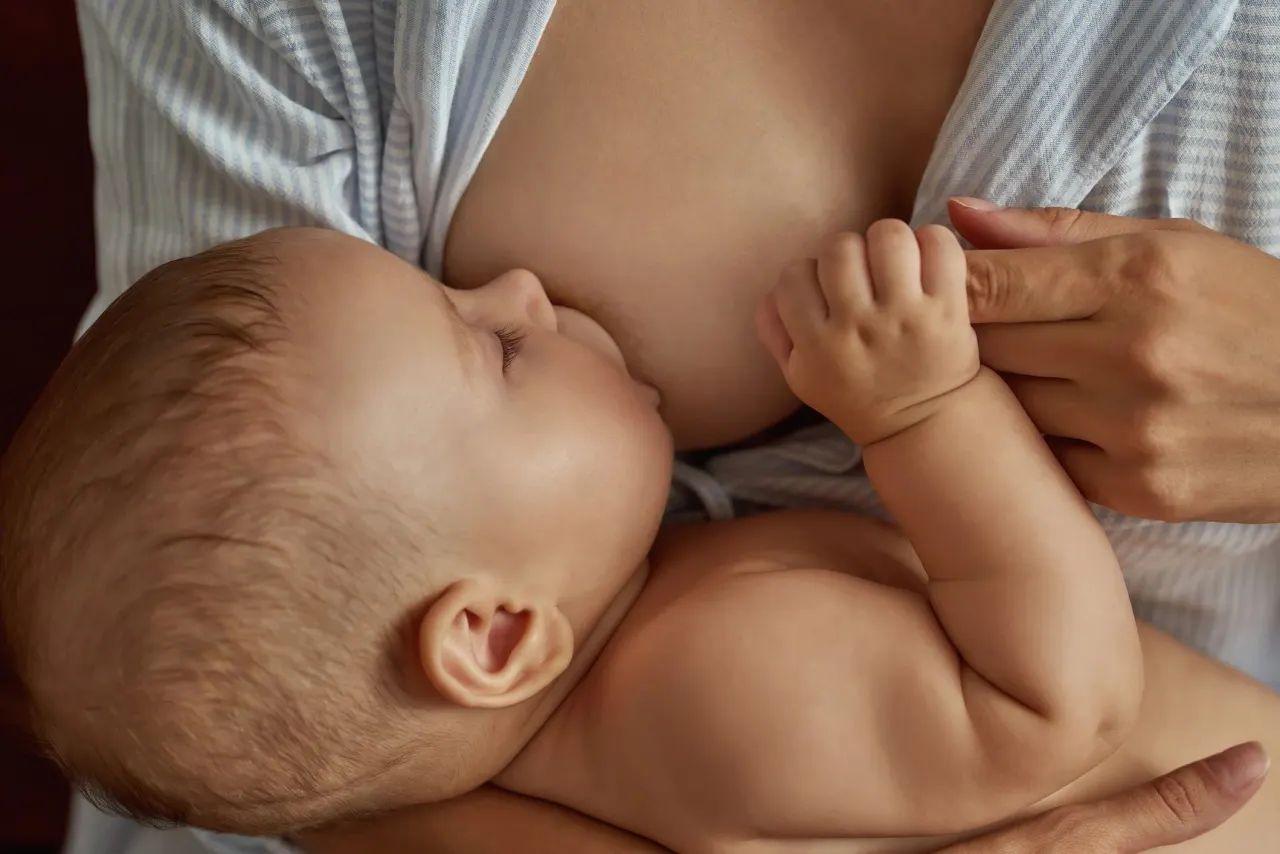 A mother breastfeeding her baby, close up